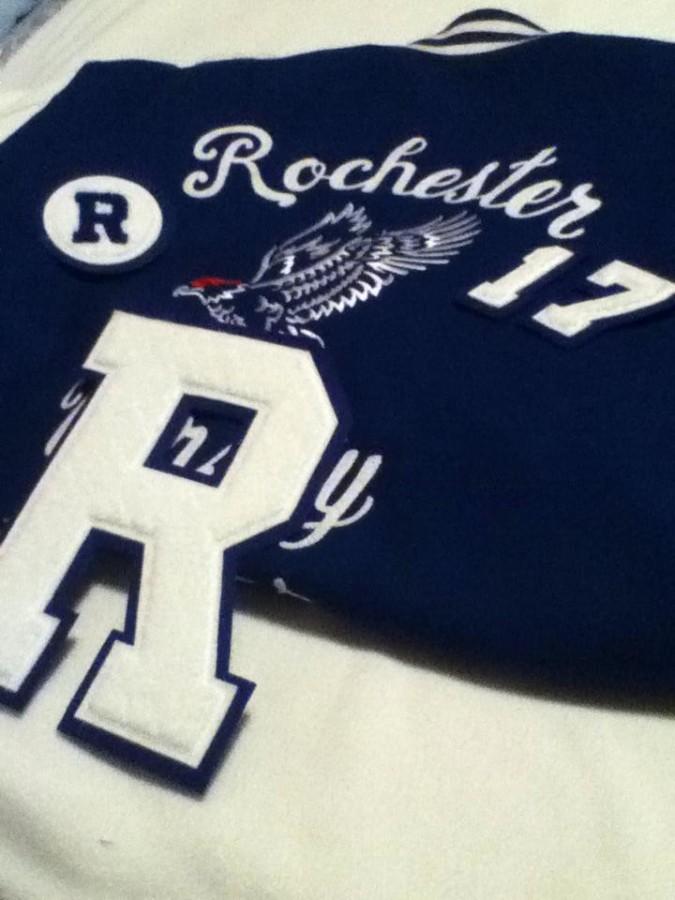 A Varsity jacket with the block R, class year numbers, and JV patch. 