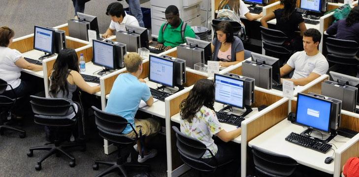 Students are taking computerized tests in a library.