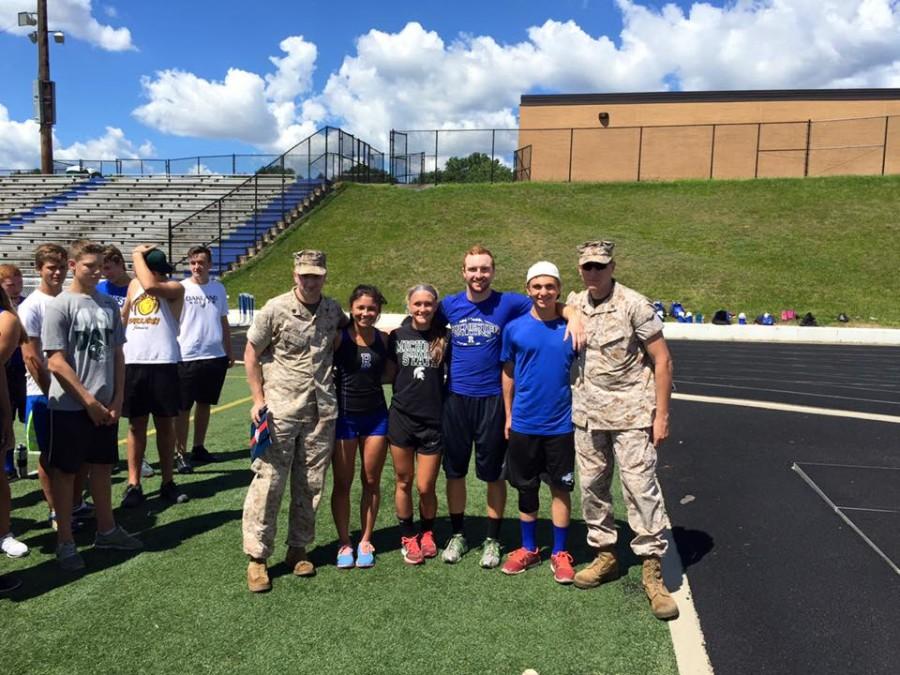 The top two female and male athletes pose with the marines after the bootcamp training session.