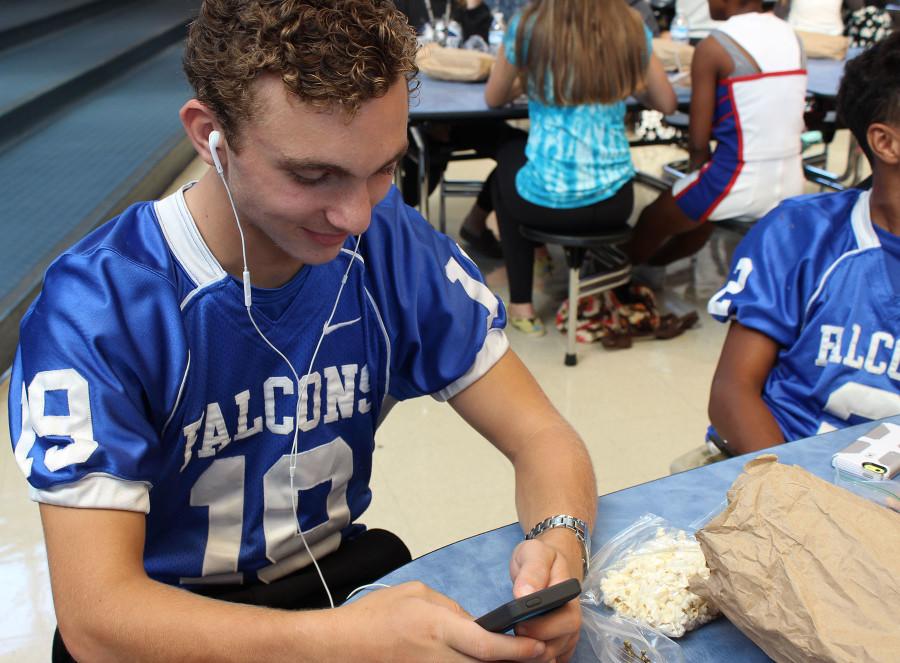 Freshmen Roman Macioce jams out to Luke Bryan during second lunch. Country music is his happy place. I love the messages and the beats. Macioce said.