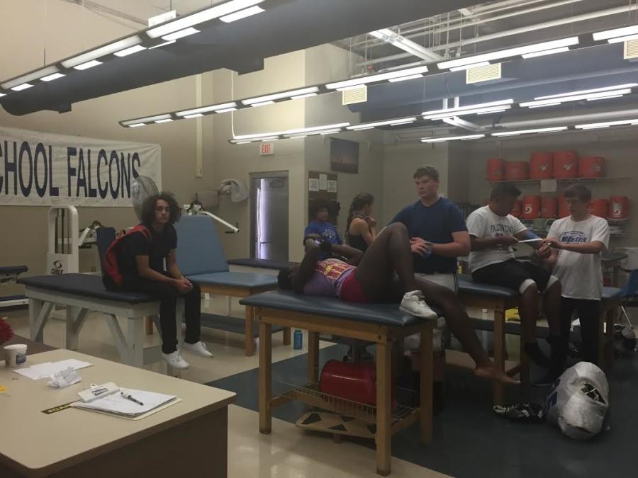 Student athletes in the training room getting wrapped.