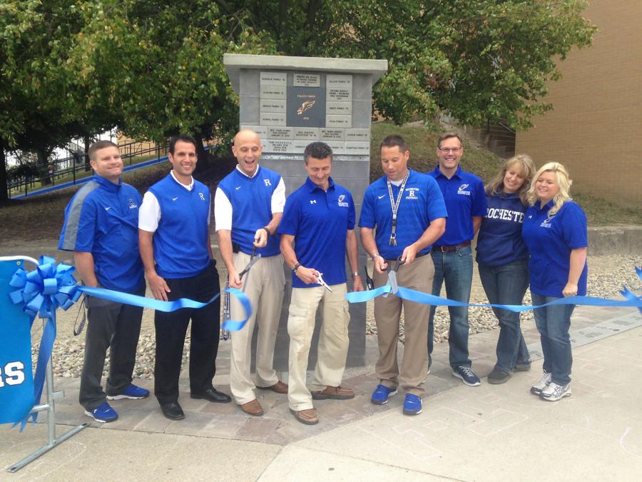 Rochester+Administration+cuts+the+ribbon+across+the+newest+athletic+entrance+additions%2C+launching+the+Brick+Paver+beautification+project+to+the+Rochester+community.