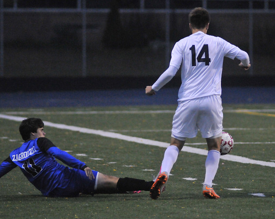 Sophomore George Zagrodzki goes in for a slide tackle against Berkley.  Photo courtesy of MI Prep Zone. 