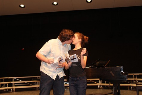 Joey Tobin and Rachel Butala kiss within a scene.