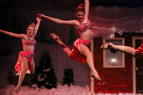 Arnold performs onstage among her dance peers,