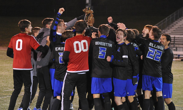 The soccer team celebrates their regional championship win after beating the Grand Blanc Bobcats. Photo Courtesy of The Oakland Press and MI Prep Zone