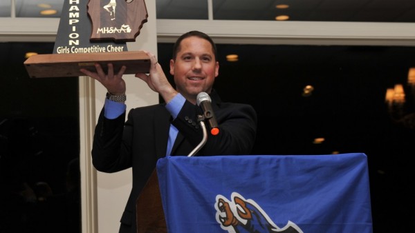 Luke Beach proudly showing off the cheer state championship award earlier this year. Photo courtesy of rhsfalcons.com