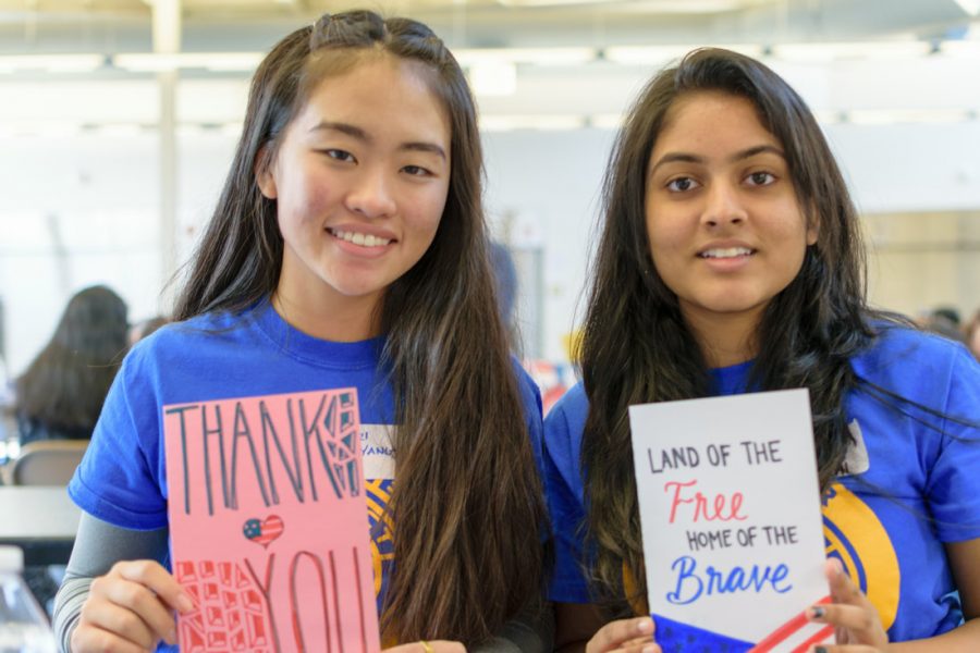 Officers Keri Yang and Preethi Surapaneni hold up the cards they made for Veterans