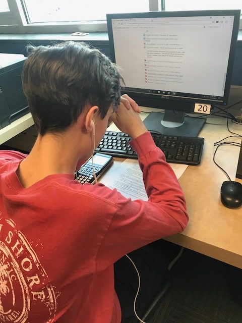 An RHS junior listens to music while working on an assignment for class. 