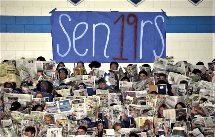 RHS seniors using newspapers to block the junior lip sync at the 2018 homecoming pep assembly. 
Photo courtesy of Tony Reedy.