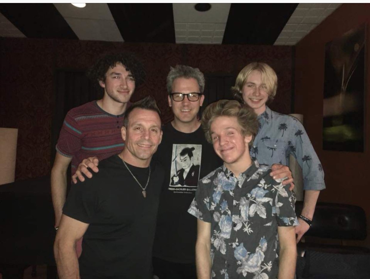 Siren poses for a picture with their sound guy as they get ready to record for their new album, “The Boys.” Photo courtesy of Deputy Curtis.